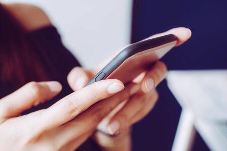 A young woman is using a mobile phoneの写真素材