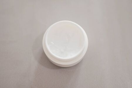 A beauty cream on a plastic container on a gray backgroundの写真素材