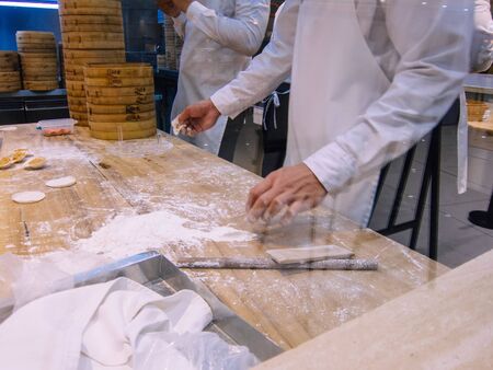 A group of chefs making dumplings in the restaurantの写真素材