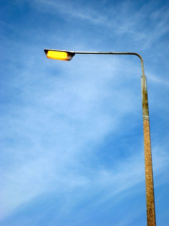 Faulty street light on during the daytimeの写真素材