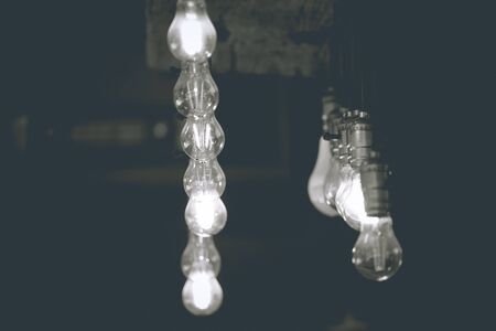 Abstract lamps hanging from ceiling in black and white colors with copy space. Abstract interior background.の写真素材
