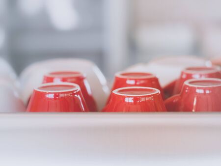 Red coffee cup upside down Arranged together on glass shelves.