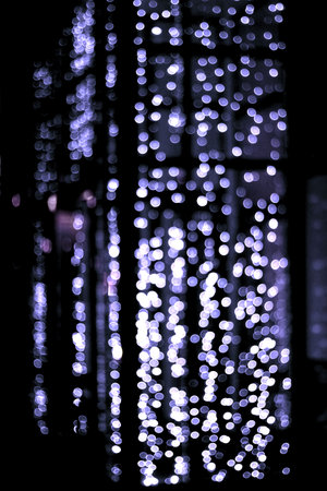 Abstract bokeh background. Colorful defocused lights on black background.の写真素材