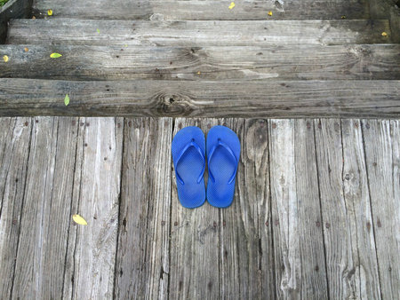 Blue slippers on wooden floorの素材