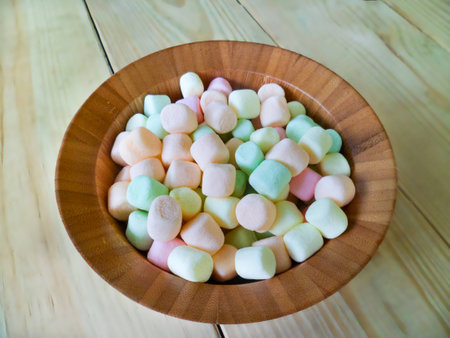 marsh mallows in wooden bowl, blur wood backgroundの写真素材