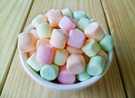 marshmallows in white bowl, blur  wood backgroundの写真素材