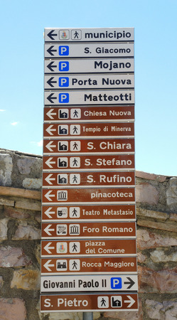 Assisi, Italy. A large number of small-scale signs showing the direction of the various monuments and main services of the cityの写真素材