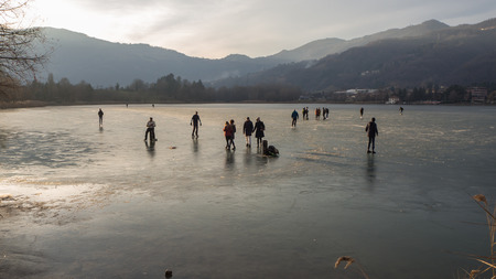 People skating and walking on the frozen lakeのeditorial素材
