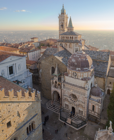 Bergamo, Italy. The old city. Aerial view of the Basilica of Santa Maria Maggiore and the Colleoni chapel during the sunset. In the background the Po plainのeditorial素材