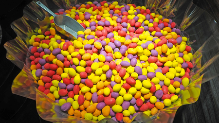 Close up of a bowls filled with a large selection of different colored soft candiesの写真素材