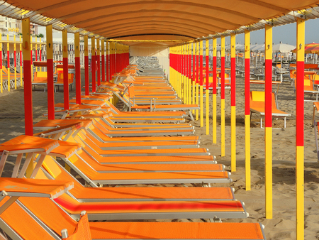 Beach umbrellas, gazebos and sun beds at Italian sandy beaches. Adriatic coast. Emilia Romagna regionのeditorial素材