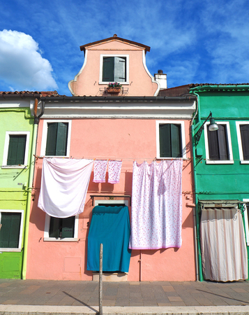 Burano, Venice, Italy. Street with colorful houses with laundry on the facadeのeditorial素材