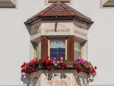 Traditional flowered balcony at the Italian Alps and dolomitesの写真素材