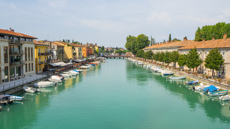 Peschiera del Garda, Italy. The beautiful historical city center. Promenade and entertainment along the water canal. Garda Lakeのeditorial素材