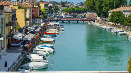 Peschiera del Garda, Italy. The beautiful historical city center. Promenade and entertainment along the water canal. Garda Lakeのeditorial素材