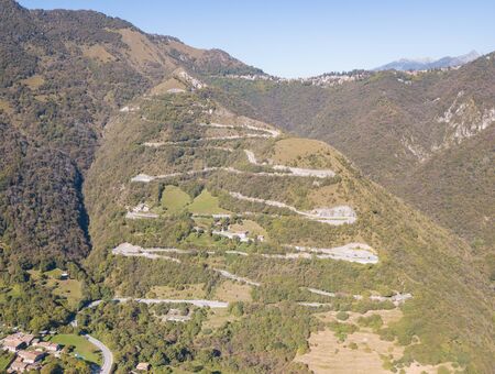 Drone aerial view of the mountain road in Italy. Bends creating beautiful shapes