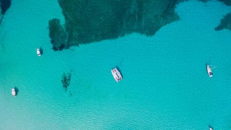 Amazing drone aerial landscape of the charming area of Es Trencs and the boats with a turquoise sea. It has earned the reputation of Caribbean beach of Mallorca. spainの写真素材