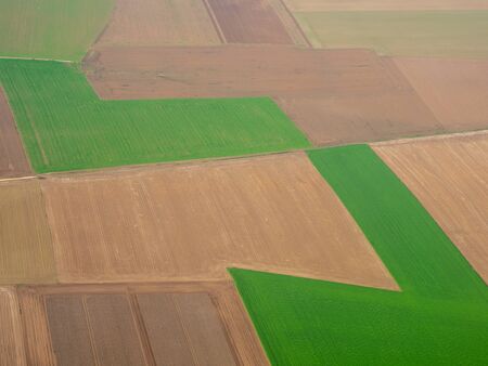 Earth's line. A vertical perspective of the ground's colors and shapes. Agricultural fields with...