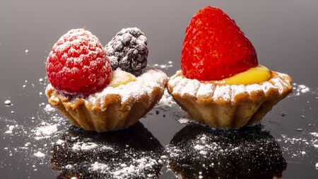 Delicious pastries with raspberry and pastries with strawberry on custard.