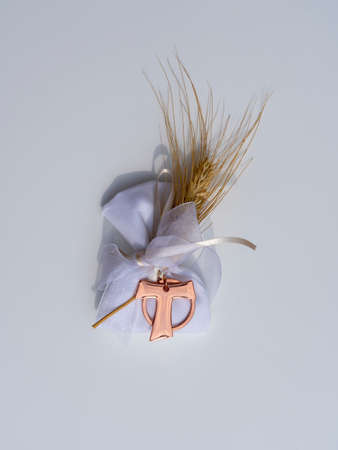Gifts or favors for the first or holy communion. Isolated small bag of white fabric with ear of...