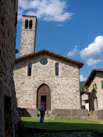 Camerata Cornello, Italy. Italian medieval ancient village. Place were it was invented the postal service and the taxi. Here first stamp ever issued. The crooked bell towerのeditorial素材