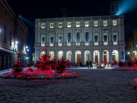 Bergamo, Italy. The main square of the old town. Landscape at the main library and buildings after a snowfall. Christmas time. Small pine trees with lights. Bergamo best of Italyのeditorial素材
