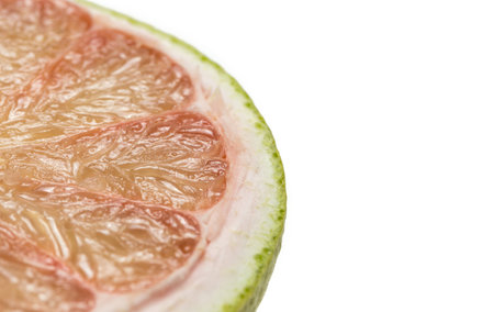Green grapefruit sweetie on white backgroundの写真素材