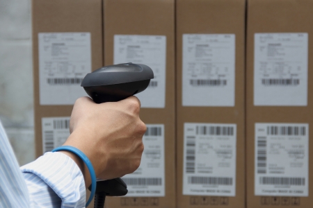 Scanning the label on the boxes with barcode scanner