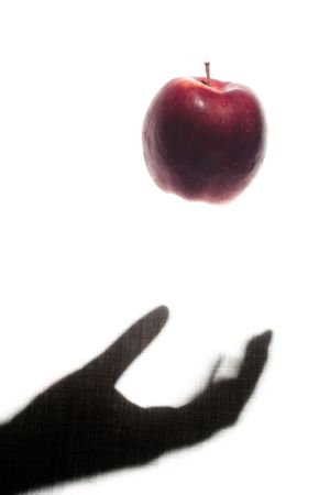 Apple Thrown by a Shadow Handの写真素材