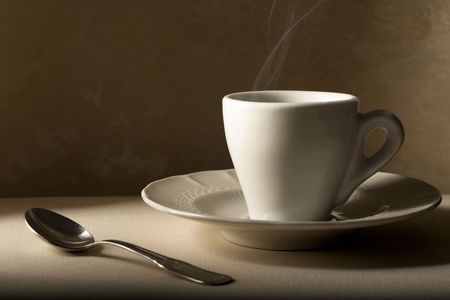 Coffee Cup with Spoon on Beigeの写真素材