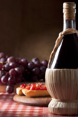 Wine Flask with Bruschetta and Grapesの写真素材