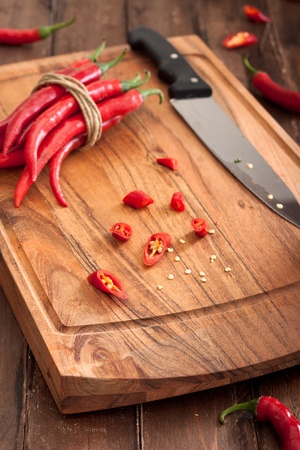 Sliced Red Chili Peppers on Wooden Cutting Boardの写真素材