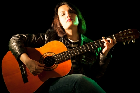 Woman Playing Classical Guitar in a Concertの写真素材