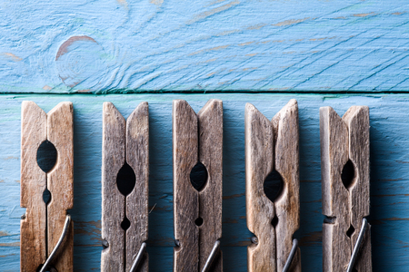 Wooden Clothespins on Blue Woodの写真素材