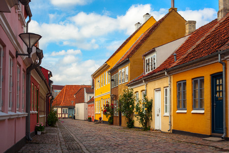 A Cobbletone Street In Odense with Coloured Housesの写真素材