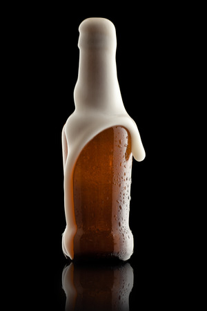 Suds Getting Out of an Overflowing Beer Bottleの写真素材