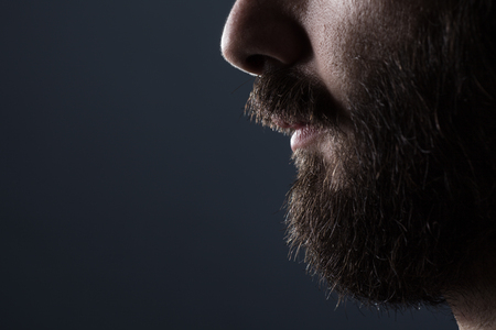 Profile Close Up of a Man with Brown Beard on Gray Backgroundの写真素材