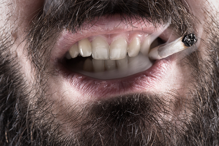 Detail of a Man with a Beard Smoking a Cigaretteの写真素材