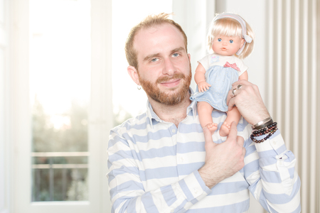 Smiling Man with a Doll on His Shoulderの写真素材