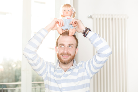 Smiling Man Holding a Doll on His Headの写真素材