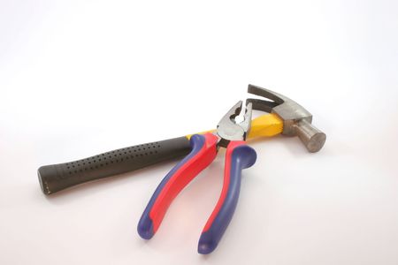 A red & blue plier and a hammer with yellow & black handle