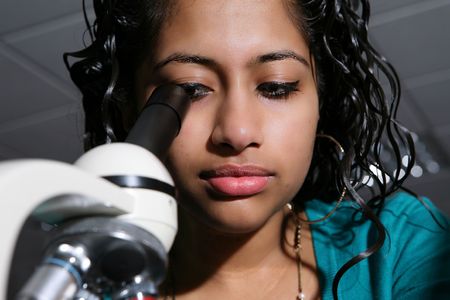 A pretty Asian student using her microscope