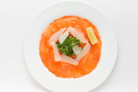 Smoked salmon carpaccio appetizer top view on a whiteの写真素材