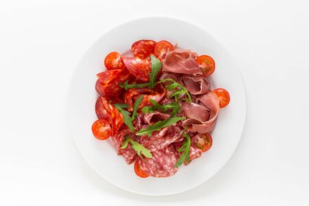 Cold meat plate with ham, proscuitto and salami served with cherry tomatoesの写真素材