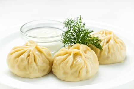 Geogrian dumpling khinkali with meat and vegetables, served with sauceの写真素材