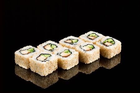 Traditional japanese sushi roll with sea eel, close up isolated on a glossy blackの写真素材