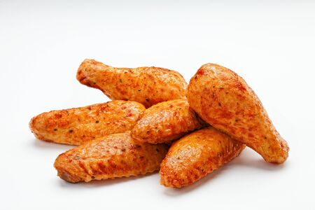 Fried crunchy chicken wings close up isolated on whiteの写真素材