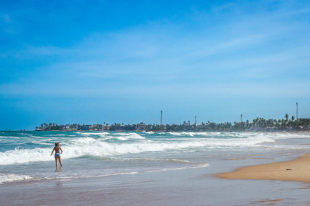 Beautiful girl in bikini walking on the beach. Porto de Galinhas, Pernambuco - Brazilの写真素材