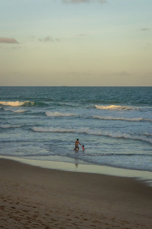 Little girl playing on the beach at sunset, Porto de Galinhas, Pernambuco - Brazilの写真素材
