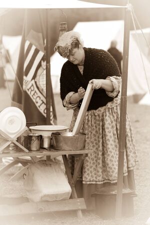 Woman performing kitchen duties in north encampment.のeditorial素材